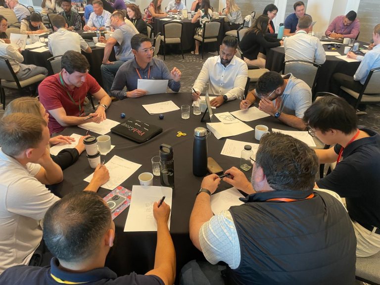 A group of colleagues together at a table during a convention.